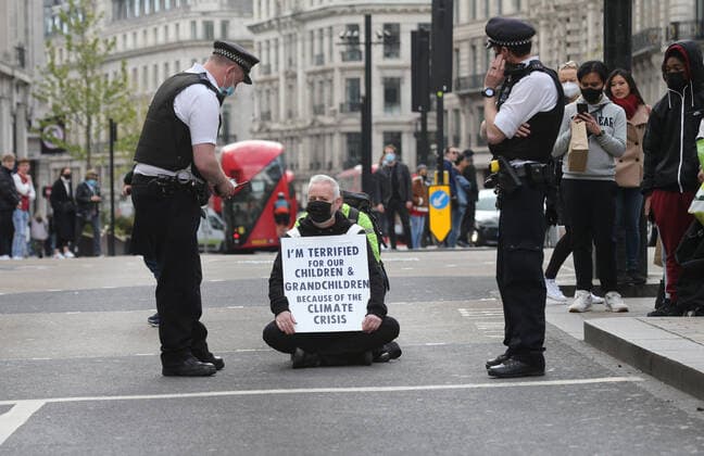 May 1, 2021, London, England, United Kingdom: An Extinction Rebellion activist blocks the road in Oxford Circus. Protester carries a sign that reads Ã¢â‚¬oeI am terrified for my children and grandchildren because of the climate crisis. London United Kingdom - ZUMAs262 20210501_zip_s262_024 Copyright: xTayfunxSalcix