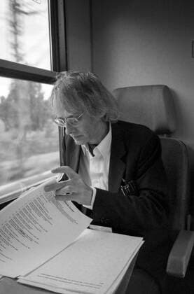Timm Ulrichs on the train from Berlin to Magdeburg correcting flags for the catalogue Der detektorische Blick NGBK , 19 9 1997 On the way to a meeting about his design for the earth axis on the station forecourt in Magdeburg, which was inaugurated in 1999 Ulrichs used the train journey to correct printed flags for his catalogue at the NGBK Der dete