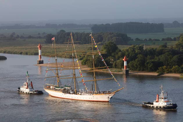 Three-master SCHULSCHIFF DEUTSCHLAND is towed by two tugs on the Weser from Bremen to Bremerhaven, where the last German full-rigged ship will be moored in the New Harbour of the Havenwelten as a museum ship. Copyright: xCarlxGrollx