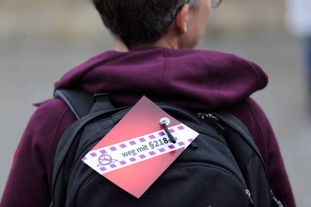 A woman holding a sign Weg mit Paragraf 218 StGB during a rally for the decriminalization of abortion on the occasion of International Safe Abortion Day at the Alter Markt in Potsdam, 28 September 2021 International Safe Abortion Day.