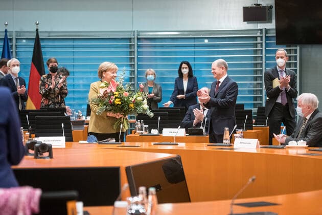 Chancellor Angela Merkel CDU with a bouquet of flowers presented by Finance Minister and Vice-Chancellor Olaf Scholz SPD on 24 November 2021 at what is expected to be her last cabinet meeting in the office of Chancellor of the Federal Government at the Chancellors Office in Berlin Cabinet meeting of the Federal Government