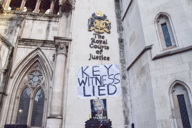 December 10, 2021, London, United Kingdom: Key Witness Lied placard is seen during the demonstration..Protesters gathered outside the Royal Courts of Justice in support of Julian Assange, as the US Government wins its appeal against the decision not to extradite the WikiLeaks founder. London United Kingdom - ZUMAs197 20211210_zaa_s197_041 Copyright: xVukxValcicx