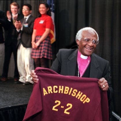 December 26, 2021: Archbishop DESMOND TUTU, the Nobel Peace Prize-winning Anglican cleric whose good humor, inspiring message and conscientious work for civil and human rights made him a revered leader during the struggle to end apartheid in his native South Africa, has died. He was 90. FILE PHOTO SHOT ON: April 13, 2000, Cuyahoga Falls, Ohio, USA: Archbishop DESMOND TUTU received a sweatshirt from Walsh Jesuit High School students in , Ohio after a speech to the student body. Cuyahoga Falls USA  - ZUMAm67_ 20000413_mda_m67_013 Copyright: xAkronxBeaconxJournalx