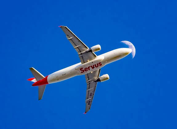 Airplane in front of moon An airplane Airbus A320 214 of Austrian Airlines landing at Frankfurt Airport in front of moon Offenbach am Main Hesse Germany