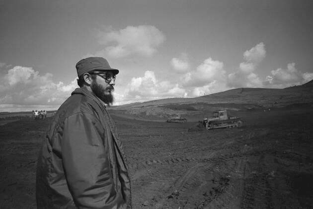 Fidel Castro standing on a field, half figure, half figure, he is watching two bulldozers at work, in 1967 in Cuba Fidel CASTRO actually Fidel Alejandro Castro Ruz , Cuba, politics, head of government of Cuba black and white, black and white, black and white, monochrome, SW monochrome, black and white photo,