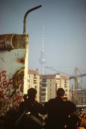In November 1989, West Berliners gather around the Brandenburg Gate to greet GDR citizens for their new freedom to travel Fall of the Wall Brandenburg Gate