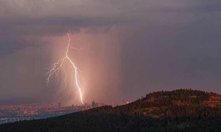 Lightning over Frankfurt A lightning strikes from the Großer Feldberg in Taunus seen in the Rhine Main area over the Frankfurt skyline , Schmitten Hesse Germany
