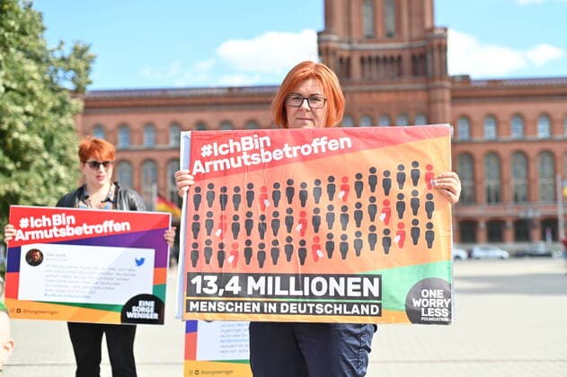 Activists of the movement IchBinArmutsbetroffen hold posters while protesting in front of the Red City Hall in Berlin for a redistribution of existing resources and against the increasing gap between rich and poor in the face of rising energy and food prices Ph Copyright: epd-bild ChristianxDitsch EDITORIAL USE ONLY