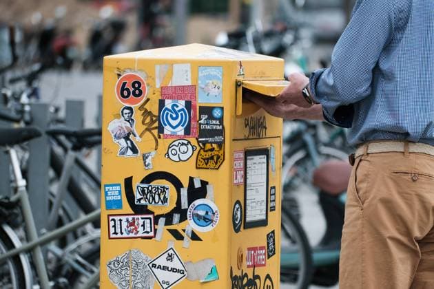 Dusseldorf 15 08 2022 mailbox yellow post letter letters DHL snailmail email letter post horn retro sticker pasted vandalism letter delivery letter election Dusseldorf North Rhine Westphalia Germany