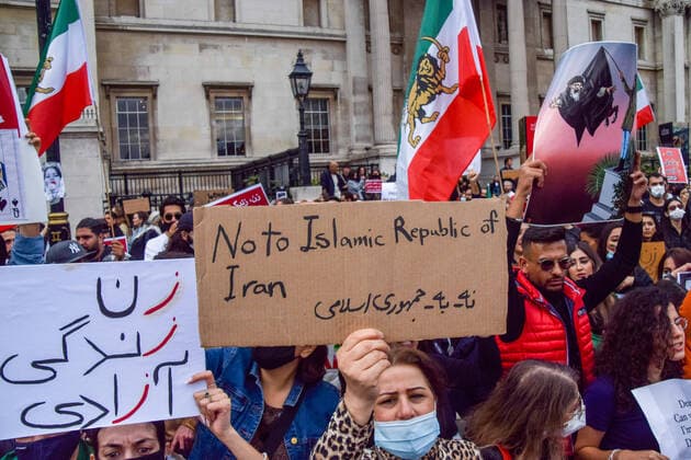 September 24, 2022, London, United Kingdom: A protester holds an anti- Islamic Republic of Iran placard during the demonstration. Thousands of Iranians and other protesters gathered in Trafalgar Square in response to the death of Mahsa Amini, who died in police custody in Iran after being detained for allegedly not wearing a head scarf (hijab) properly in public. London United Kingdom - ZUMAs197 20220924_zaa_s197_227 Copyright: xVukxValcicx