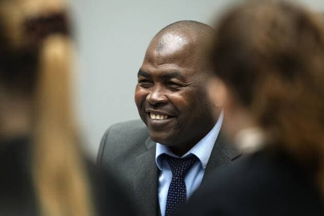 2022 09 26 09 25 12 Mahamat Said Abdel Kani talks to his defense lawyers in the court room of the International Criminal Court in The Hague, Netherlands, Monday, Sept 26, 2022 The trial of an alleged commander in a mainly Muslim rebel group from Central African Republic opened and charged Said with crimes against humanity and war crimes AP Ph  Copyright: xx x455370619x originalFilename: 455370619.jpg