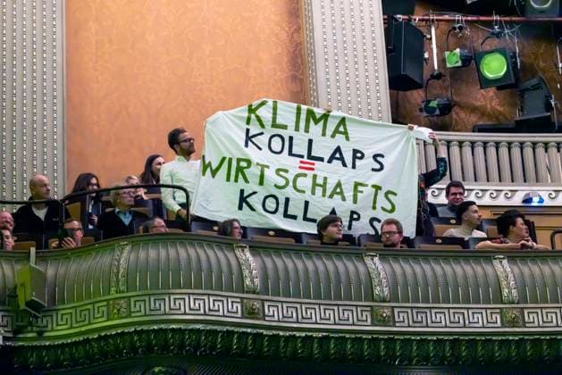 Climate activists disrupt event during Christian Lindners speech On banners they share Climate collapse equals economic collapse, Epiphany 2023 meeting of the FDP in Stuttgart 06 01 2023 Stuttgart, Baden Württemberg, Germany
