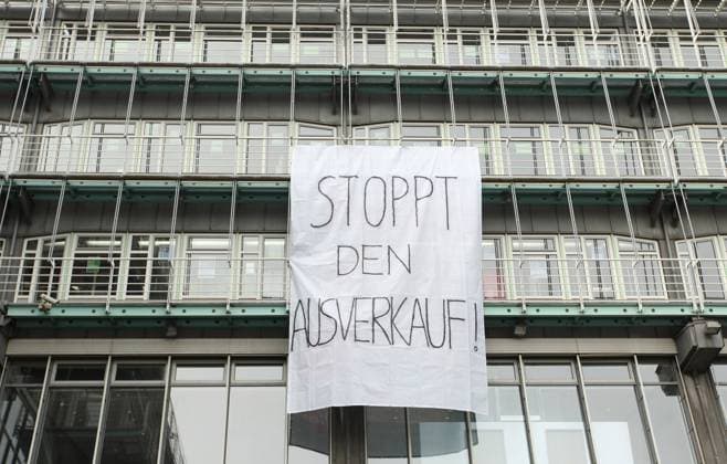 On the façade of the publishing building of the media company Gruner Jahr at Baumwall at the Hamburg harbor hangs a huge poster with which employees of Gruner Jahr protest against the job cuts announced by the publishers owner RTL 700 jobs are to be cut at the traditional company Old Town Hamburg