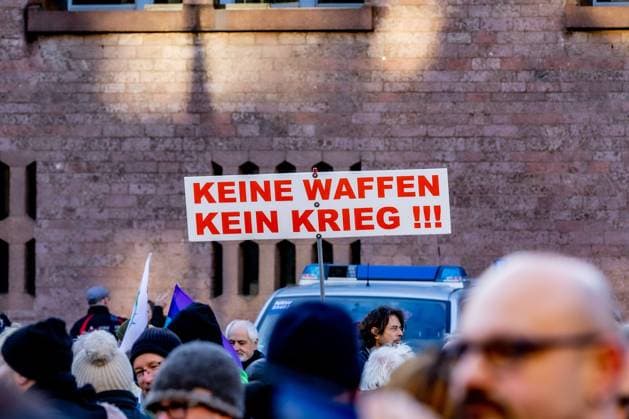 Sign No Weapons No War Action Weekend öStop the Killing for Ceasefire and Negotiations ˜ by Deutsche Friedensgesellschaft Vereinigte KriegsdienstgegnerInnen at the Alter Markt in Cologne 25 02 2023 Cologne Altstadt NRW Germany