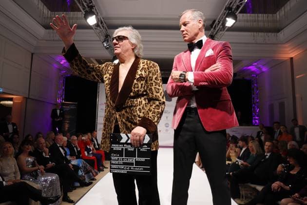 25 03 2023 Neu Isenburg, Kempinski Hotel Gravenbruch Clothes make the man Benefit Gala Claude Oliver Rudolph actor, producer, screenwriter and film director for the good cause as a model on the catwalk here with the original Sacko of Rainer Werner Fassbinder in the film KAMIKAZE here with Gentlemen Henry Mask HP