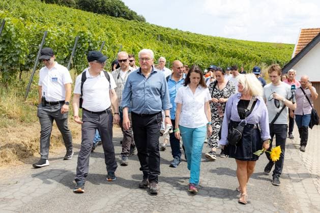 In conversation with District Administrator for the Ahrweiler district Cornelia Weigand right Federal President Frank Walter Steinmeier visits the red wine hiking trail from Bad Neuenahr Ahrweiler to Marienthal together with his wife Elke Büdenbender before the second anniversary of the flood disaster in the Ahr valley and talks