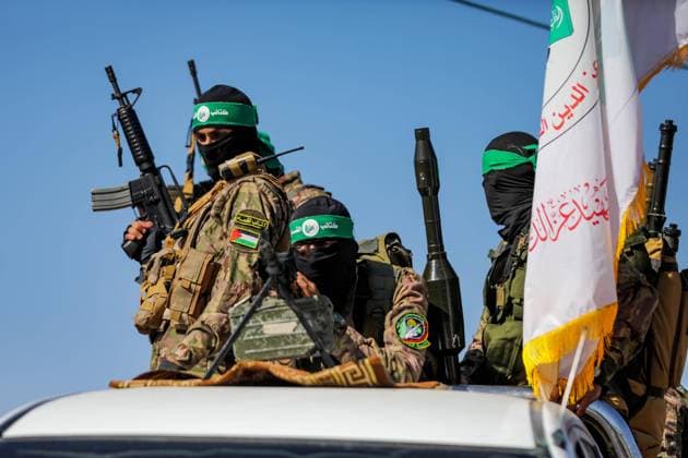 July 19, 2023: Gaza, Palestine. 19 July 2023. Fighters from the Izz al-Din al-Qassam Brigades, the military wing of Hamas, take part in a military parade near the border with Israel in the central Gaza Strip, during a commemoration of the 2014 Gaza war. The 51-day conflict between Gaza and Israel in 2014 caused huge and unprecedented human loss, destruction, and devastation in the Gaza Strip - ZUMAd99_ 20230719_zap_d99_010 Copyright: xYousefxMohammedx