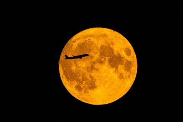 The Blue Moon with a, from the airport BER taken off airplane, in the evening of the 30 August 2023 in the sky over Brandenburg As Bluemoon one calls the rare event, if there are two full moons in one month Blue Moon