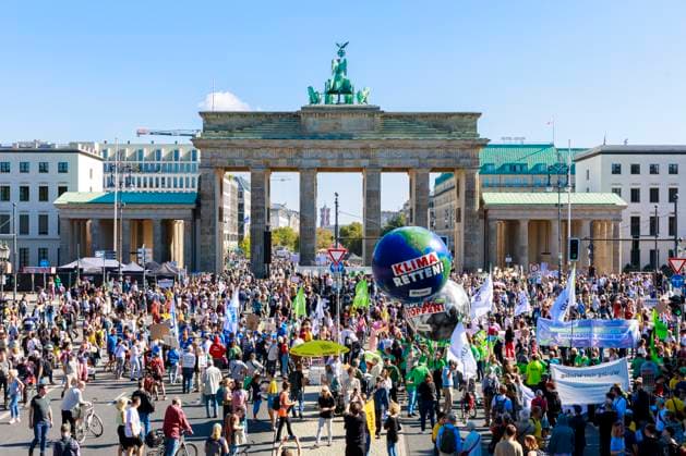 13 global climate strike 15 09 23 Germany, Berlin on 15 September 2023 demonstrators in front of the Brandenburg Gate with placards and banners and a large balloon with the script Climate Save