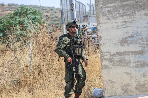 September 29, 2023, Nablus, Palestine: An Israeli soldier stands alert around an Israeli checkpoint near the Palestinian town of Beit Furik, east of Nablus, in the northern West Bank. A speeding car tried to run over a number of occupation soldiers stationed at the checkpoint they were guarding, which led to their alert. Nablus Palestine - ZUMAs197 20230929_aab_s197_001 Copyright: xNasserxIshtayehx