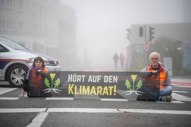 St Pölten, Austria 30 October 2023 Members of the Last Generation Austria block the early morning traffic in the capital of Lower Austria to demand more climate protection of the Lower Austrian government