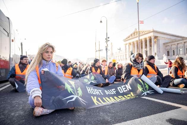 Vienna, Austria December 8, 2023 Climate activists from the group Letzte Generation Österreich stick themselves in front of the Austrian parliament during a publicly announced action Picture shows German climate activist Anja Windl Vienna on the left