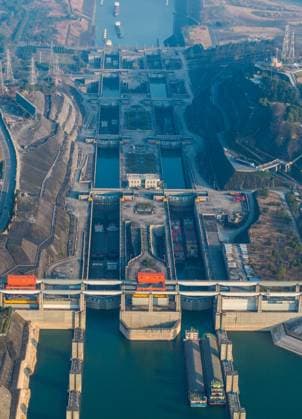 (240111) -- YICHANG, Jan. 11, 2024 -- An aerial drone photo taken on Jan. 11, 2024 shows vessels passing through the five-tier ship locks of the Three Gorges Dam in Yichang, central China s Hubei Province. The cargo throughput via the Three Gorges Dam, the world s largest hydropower project on the upper stream of the Yangtze River, reached a record high of 172.34 million tonnes in 2023, up 7.95 percent year on year, according to the China Three Gorges Corporation. (Photo by Xinhua) CHINA-HUBEI-YICHANG-THREE GORGES DAM-CARGO THROUGHPUT (CN) WangxGang