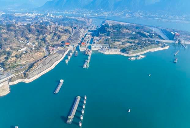 (240111) -- YICHANG, Jan. 11, 2024 -- An aerial drone photo taken on Jan. 11, 2024 shows vessels passing through the five-tier ship locks of the Three Gorges Dam in Yichang, central China s Hubei Province. The cargo throughput via the Three Gorges Dam, the world s largest hydropower project on the upper stream of the Yangtze River, reached a record high of 172.34 million tonnes in 2023, up 7.95 percent year on year, according to the China Three Gorges Corporation. (Photo by Xinhua) CHINA-HUBEI-YICHANG-THREE GORGES DAM-CARGO THROUGHPUT (CN) ZhengxJiayu
