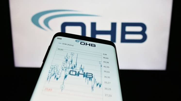 Smartphone with website of German aerospace company OHB SE on screen in front of business logo. Stuttgart, Germany - 09-10-2023: Smartphone with website of German aerospace company OHB SE on screen in front of business logo. Focus on top-left of phone display. Copyright: xZoonar.com TimonxSchneiderx 21082499