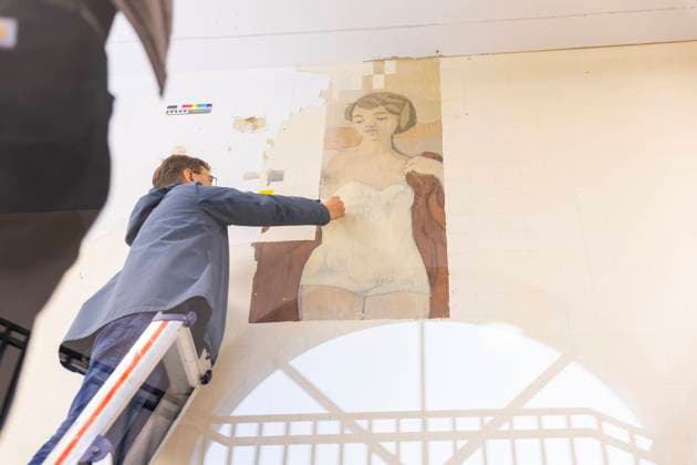 LIVING JOY A Mural by GERHARD RICHTER AT THE GERMAN HYGIENE MUSEUM THE PARTIAL EXPOSURE OF RICHTERS 1956 DIPLOMAPY HAS BEGUN Restorer Albrecht Körber demonstrates the uncovering work Dresden Saxony Germany