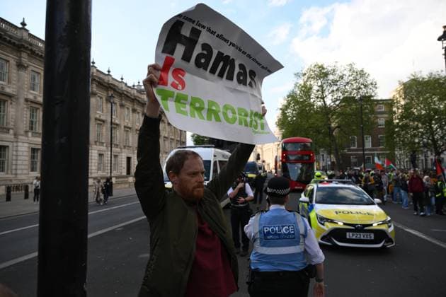 May 7, 2024, London, England, United Kingdom: One counter protester holds a banner reading Ã¢â‚¬oeHamas are terroristsÃ¢â‚¬Â during the emergency protest for Palestine. London United Kingdom - ZUMAf183 20240507_zip_f183_043 Copyright: xCalxFordx