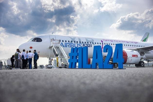 ILA 2024 Berlin Germany, Berlin Brandenburg Schönefeld on 07 06 2024 ILA24 in large 3D letters in front of an Airbus A321 XLR Xtra Long Range aircraft