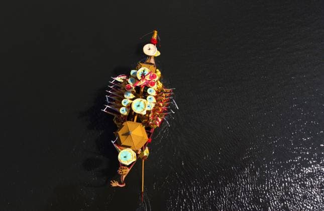 (240609) -- SHANGHAI, June 9, 2024 -- An aerial drone photo taken on June 6, 2024 shows a Luodian dragon boat sailing on the water of Meilan Lake in Baoshan District, east China s Shanghai. Originated in the Ming Dynasty (1368-1644), the dragon boating customs in Luodian, located in east China s Shanghai Baoshan District, has kept prosperous with long-lasting vitality. Nowadays, the dragon boating customs in Luodian has become an iconic folk custom activity during Dragon Boat Festival in Shanghai. It was listed as a national intangible cultural heritage in 2008. Over the years, Zhang Guomin and Zhang Guozhong from a shipbuilding family have been making efforts to preserve the dragon boat making techniques. They have been teaching younger