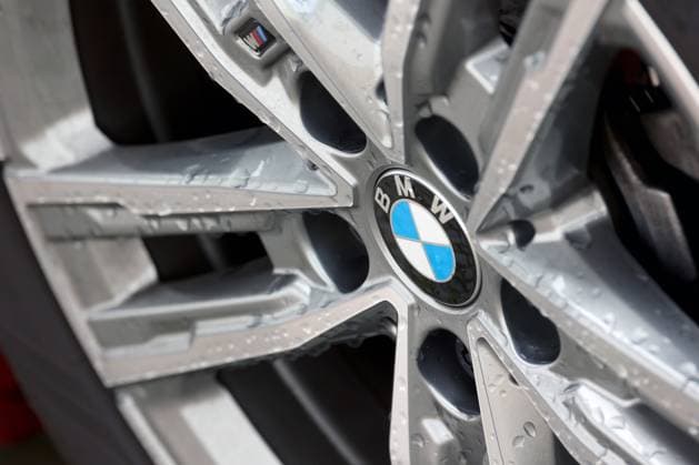 BMW logo on a BMW vehicle, rim There are drops of water on the logo and the rim BMW on 12 07 2024 in Siegen Germany