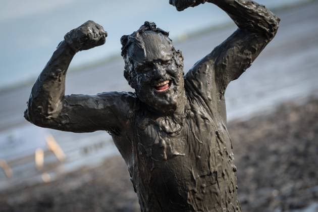 Hundreds of waders from all over Germany compete for medals at the Brunsbüttel Wattolümpiade Nonsense in the mud Probably the dirtiest games in the world 20 years and probably the last Wattolümpiade in the mudflats off Brunsbüttel, Brunsbüttel Schleswig Holstein Germany mudflats