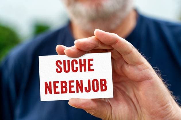 August 21, 2024: Old man holding a sign with the inscription: Looking for part-time job. PHOTOMONTAGE
