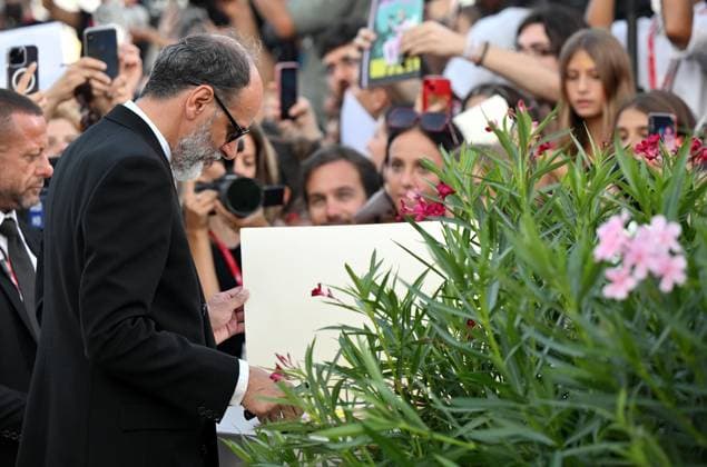 September 3, 2024, Venice, ITALY: Italian director Luca Guadagnino signs autographs as he arrives for the premiere of Queer during the 81st Venice Film Festival in Venice, Italy, 03 September 2024. The movie is presented in official competition Venezia 81 at the festival running from 28 August to 07 September 2024. ANSA ETTORE FERRARI Venice ITALY  - ZUMAa110 20240903_zaf_a110_101 Copyright: xEttorexFerrarix