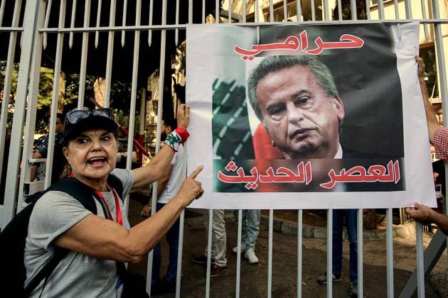 September 5, 2024, Beirut, Beirut, Lebanon: A depositor points to the picture of LebanonÃ¢â‚¬â ¢s former central bank governor Riad Salameh displayed at the entrance of the countryÃ¢â‚¬â ¢s judiciary palace in Beirut with the slogan that reads:Ã¢â‚¬Â Modern-day thiefÃ¢â‚¬Â. Scores of Lebanese depositors gathered outside the magistrates demanding the trial of Salameh, who was arrested over embezzlement, money-laundering and fraud. Beirut Lebanon - ZUMAn313 20240905_zip_n313_001 Copyright: xMarwanxNaamanix