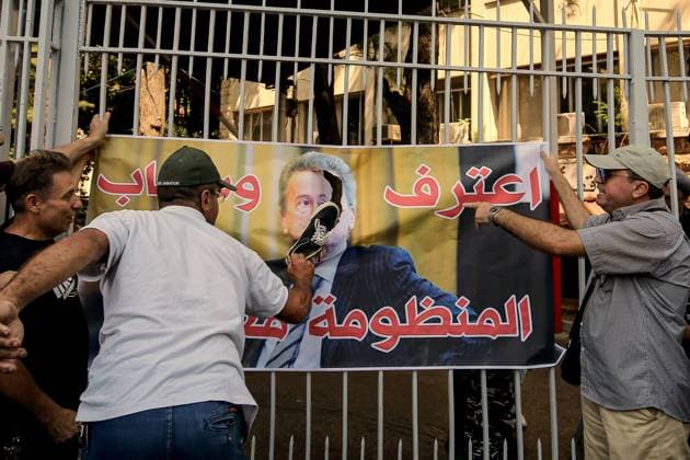 September 5, 2024, Beirut, Beirut, Lebanon: A depositor slaps with a shoe a picture of LebanonÃ¢â‚¬â ¢s former central bank governor Riad Salameh displayed at the entrance of the countryÃ¢â‚¬â ¢s judiciary palace in Beirut with the slogan that reads:Ã¢â‚¬Â Confess and drag the (corrupted) System with youÃ¢â‚¬Â. Scores of Lebanese depositors gathered outside the magistrates demanding the trial of Salameh, who was arrested over embezzlement, money-laundering and fraud. Beirut Lebanon - ZUMAn313 20240905_zip_n313_002 Copyright: xMarwanxNaamanix