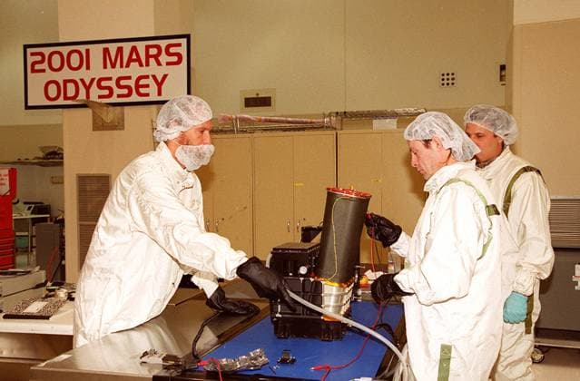 RECORD DATE NOT STATED In the Spacecraft Assembly and Encapsulation Facility 2, workers test the Thermal Emission Imaging System (THEMIS) before attaching to the 2001 Mars Odyssey Orbiter. THEMIS will map the mineralogy and morphology of the Martian surface using a high-resolution camera and a thermal infrared imaging spectrometer. The orbiter will carry three science instruments THEMIS, the Gamma Ray Spectrometer (GRS), and the Mars Radiation Environment Experiment (MARIE). The GRS will achieve global mapping of the elemental composition of the surface and determine the abundance of hydrogen in the shallow subsurface. The MARIE will characterize aspects of the near-space radiation environment with regards to the radiation-related risk to human explorers. The Mar Copyright: xpiemagsx piemagsnasaend23-15884 !ACHTUNG AUFNAHMEDATUM GESCHÄTZT!