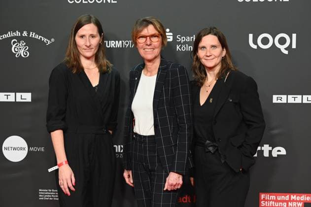 Award winners Sina Tonk and Nastassja Wachsmuth and presenter and laudator Bettina Böttinger m pose before the presentation of the NRW Media Award for Development Commitment at the Film Festival Cologne 2024, FFCGN, in the Cologne Filmpalast