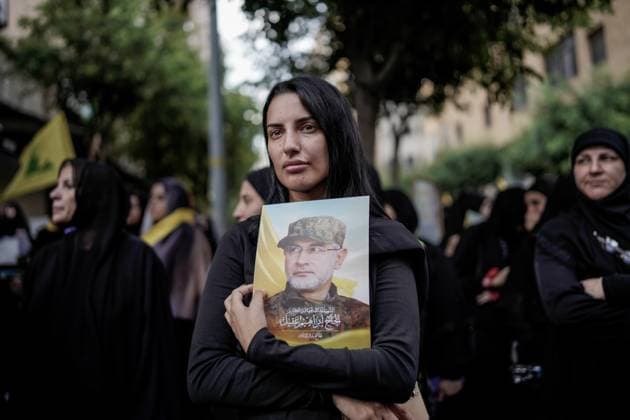 September 22, 2024, Beirut, Beirut, Lebanon: Lebanese woman holding photo of Hezbollah commander IBRAHIM AQIL at his funeral in Dahiya, Beirut, Lebanon. Dahiya is a predominantly Shia Muslim suburb in the south of Beirut. Beirut Lebanon  - ZUMA 20240922_int_m272_004 Copyright: xMohammadxMohsenifarx