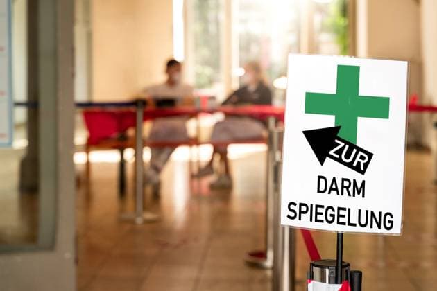 Germany - June 20, 2024: For a colonoscopy! It says on a sign in a doctor s surgery, or in a gastroenterology practice. You can see medical assistants. Symbolizes the performance of a colonoscopy to detect and remove any polyps that may be present, which can be precursors of colon cancer. PHOTOMONTAGE