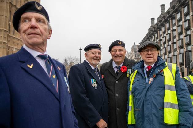 November 10, 2024, London, United Kingdom: A group of military veterans posing with a Poppy Cab marshal. Founded fifteen years ago by London taxi drivers, Poppy Cabs provides free journeys for military veterans attending the annual Remembrance Day Service at the Cenotaph in Westminster, London. Inspired by the Royal British Legion™s Poppy Appeal, where red poppy badges are exchanged for charitable donations, these dedicated taxi drivers organise themselves under the Poppy Cabs initiative. Each year, drivers offer complimentary rides to veterans from major train stations across London, ensuring they arrive safely and punctually for the commemorative event. London United Kingdom - ZUMAs197 20241110_aab_s197_036 Copyright: xJamesxWilloughbyx