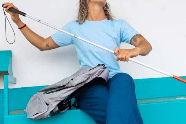 A woman confidently navigates her environment using a white cane Her determination and adaptability in daily tasks highlight resilience despite hearing and sight challenges Model Released JuanAizpuru_ID25147_727808_016 Copyright: xJuanxAizpurux