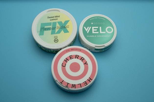 Nicotine pouches from Zyn, Velo and Skruf , Germany, 06 01 2025, Three nicotine pouches of different brands Zyn, Velo, Skruf and flavors on a blue background Modern tobacco alternative in focus Editorial use only