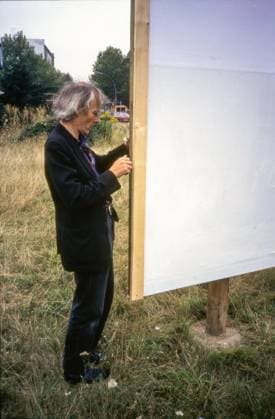 Timm Ulrichs on one of his still empty billboards, traffic island, Moritzplatz, Berlin, August 1997