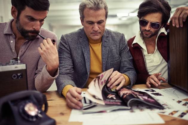 Three designers clad in retro 70s wear working on a project together., model released, , 47261038.jpg, style, business, businessperson, hippie, masculine, vintage, group, groovy, macho, job, working, 70s, seventies, businesspeople, trendy, retro photography, clothing, fashion, vintage photography, retro, designer, three, corporate, young, people, mature, male, adult, men, team, work, inside, person, handsome, desk, creative, caucasian, serious, teamwork, cropped, telephone, smoking, career, brainstorming, hip, colleague, magazine, occupation, manly, middle aged RECORD DATE NOT STATED