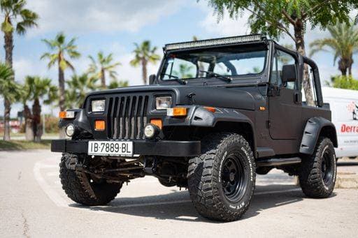 RECORD DATE NOT STATED Close-up of a spectacular first generation 1987-1996 black Jeep Wrangler YJ, modified with large wheels, fenders and upper light bar 25716239