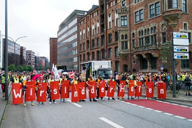 Hamburg Demonstration the Dockworkers with Verd I Flags Banner transparent with the Inscription We are the Port Hundreds demand more Wages and better Working conditions the Demonstration led to mas